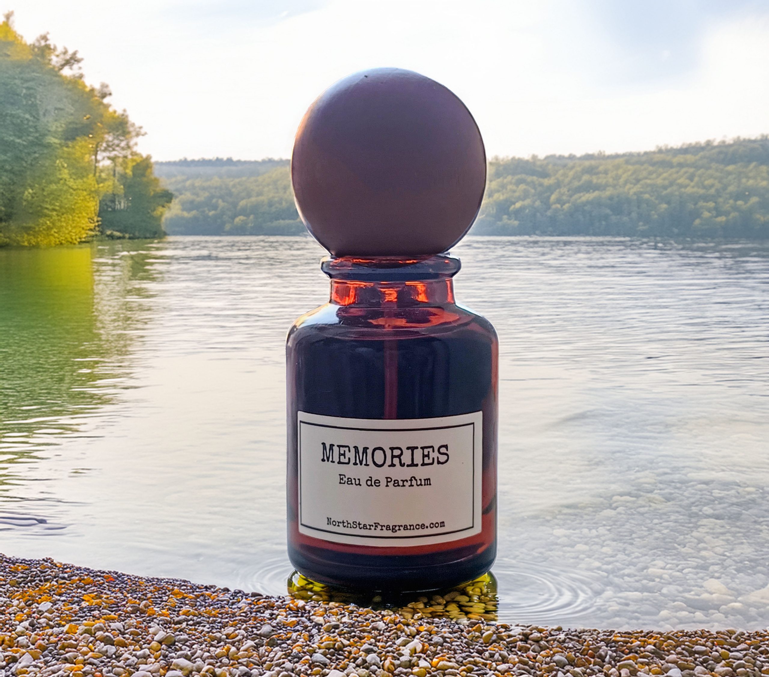 Memories Eau de Parfum by NorthStarFragrance.com on a pebbled lake shore